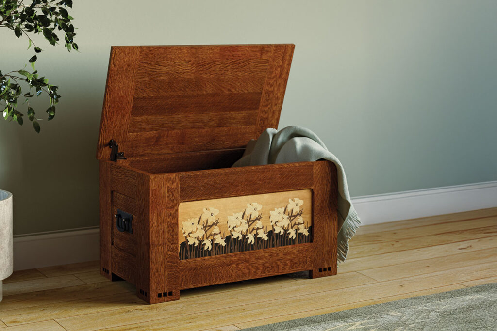 Stickley Daffodil Chest open with cedar-lined interior and cozy blanket inside, featuring handcrafted daffodil inlay on quartersawn white oak, 125th Anniversary limited-edition furniture