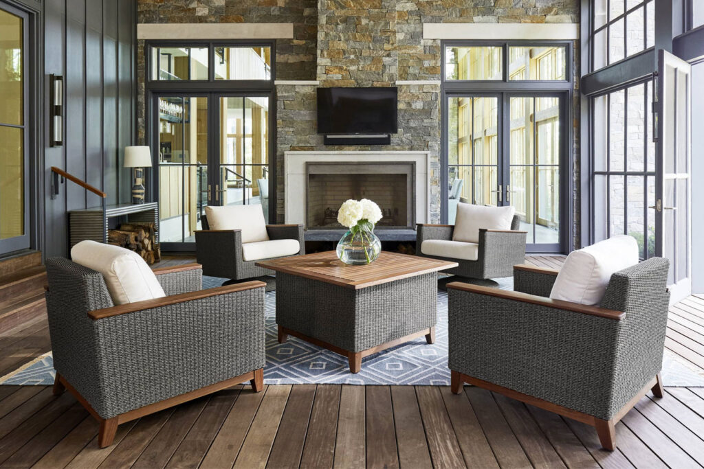 Modern patio styling with organic wood stump tables and navy blue accent cushions in Chattanooga, Tennessee.
