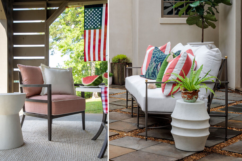 A beautifully styled stone patio featuring a luxury metal-frame armchair with coral pink cushions and a matching sofa with white cushions, accented by red-and-white striped pillows, green accents, and a fresh watermelon slices display under an American flag.