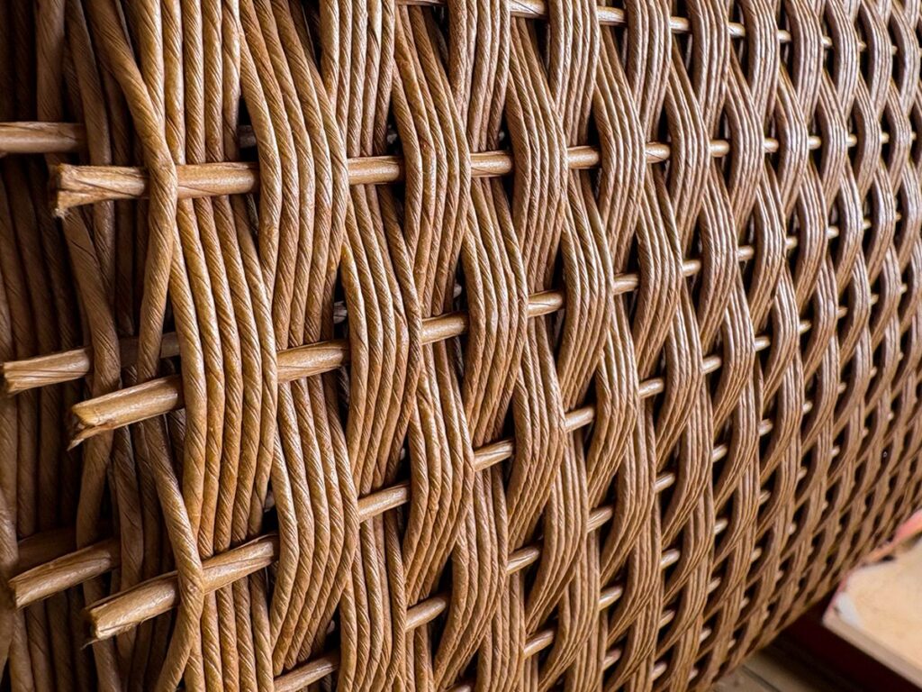 Close-up detail of all-weather resin wicker weave on premium outdoor dining furniture available at Fowler Brothers Co. in Chattanooga