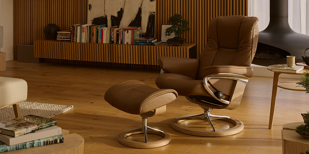 Stressless Mayfair leather recliner and ottoman in a warm brown finish in a modern living room
