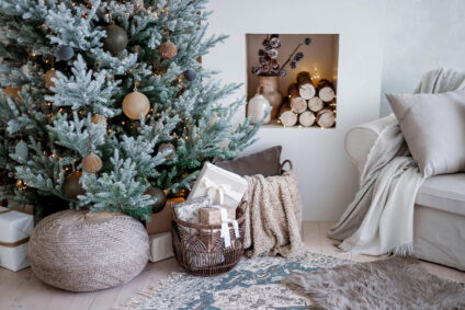 Cozy holiday gatherings setup featuring a Christmas tree, wrapped gifts, and a plush sofa with throw blankets